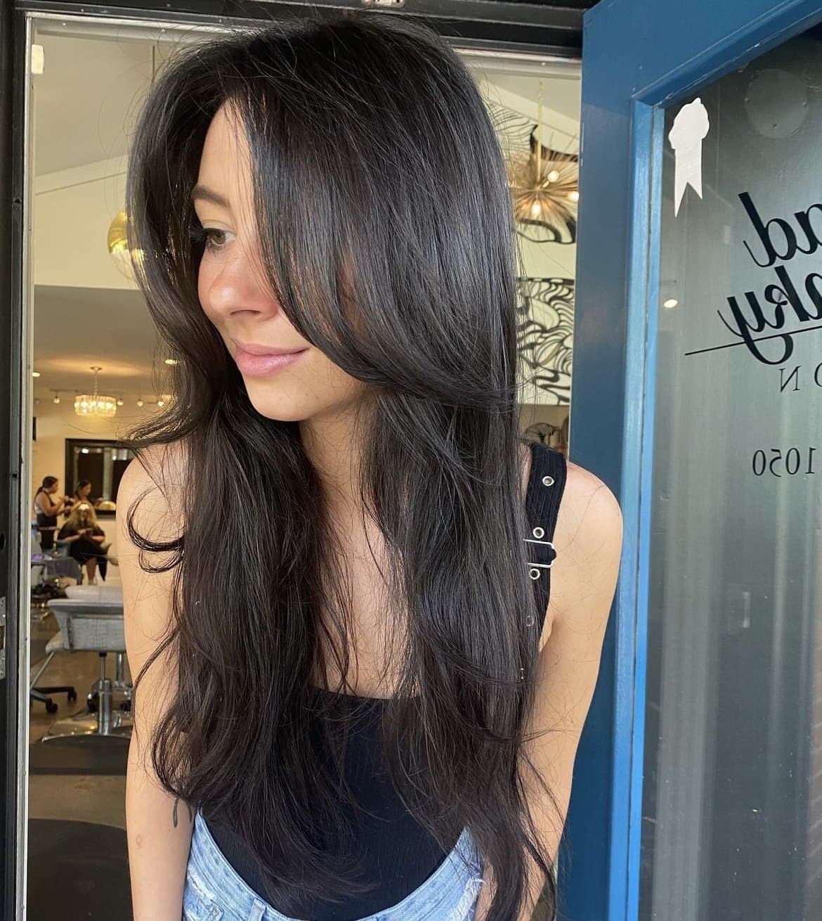 Long dark hair with curtain bangs and soft layers