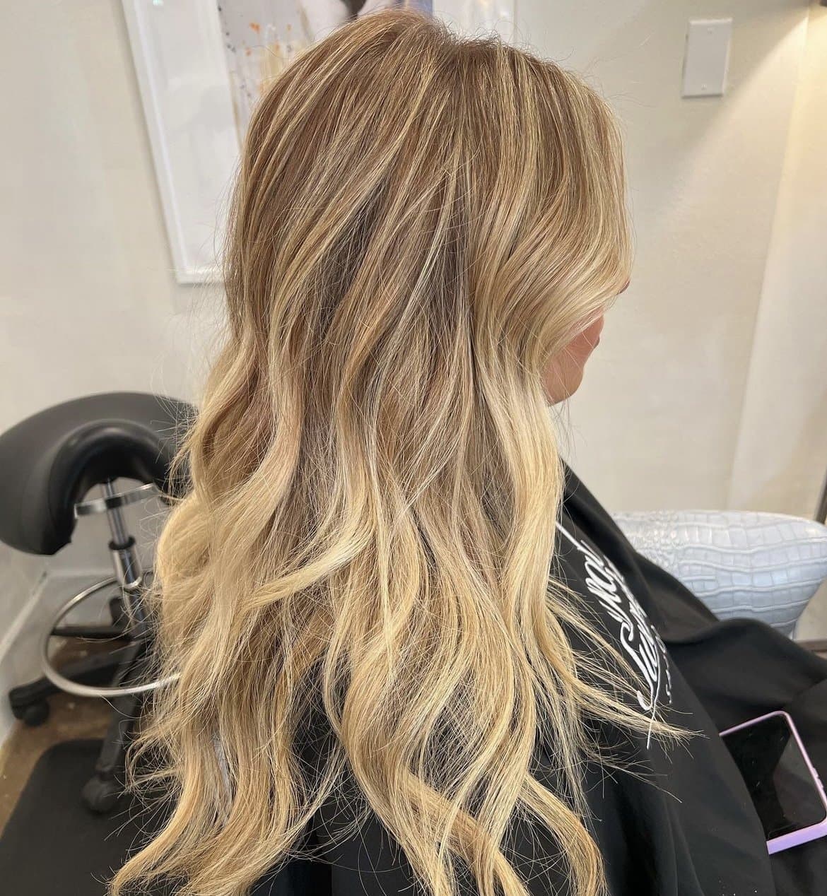 Golden blonde balayage in brushed-out waves