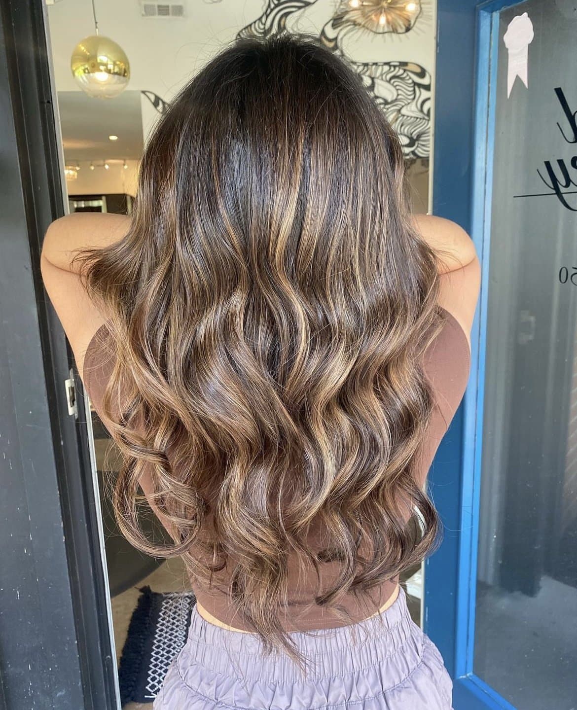 Long brunette waves with caramel balayage, from behind