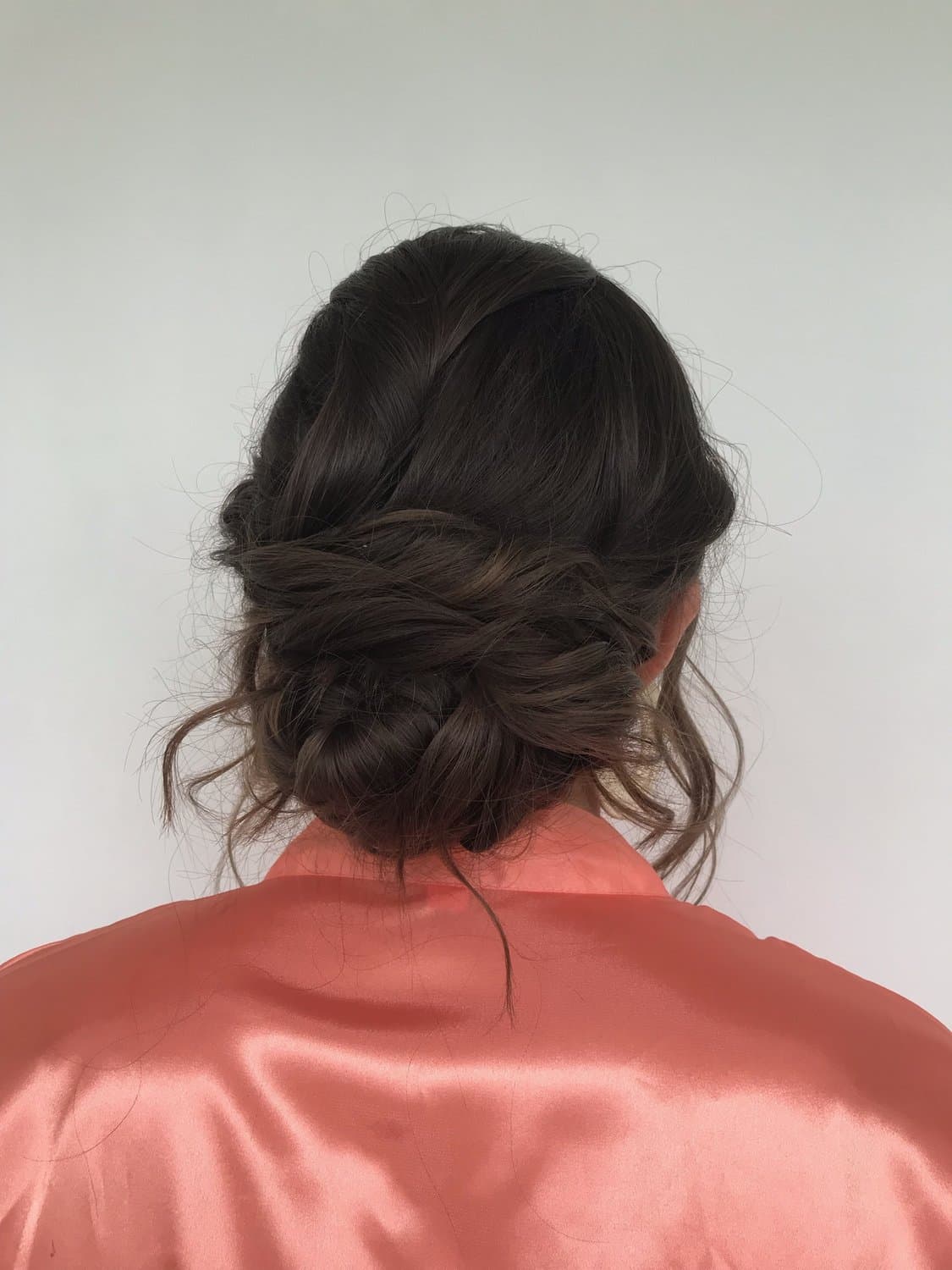 A soft, textured updo on dark hair