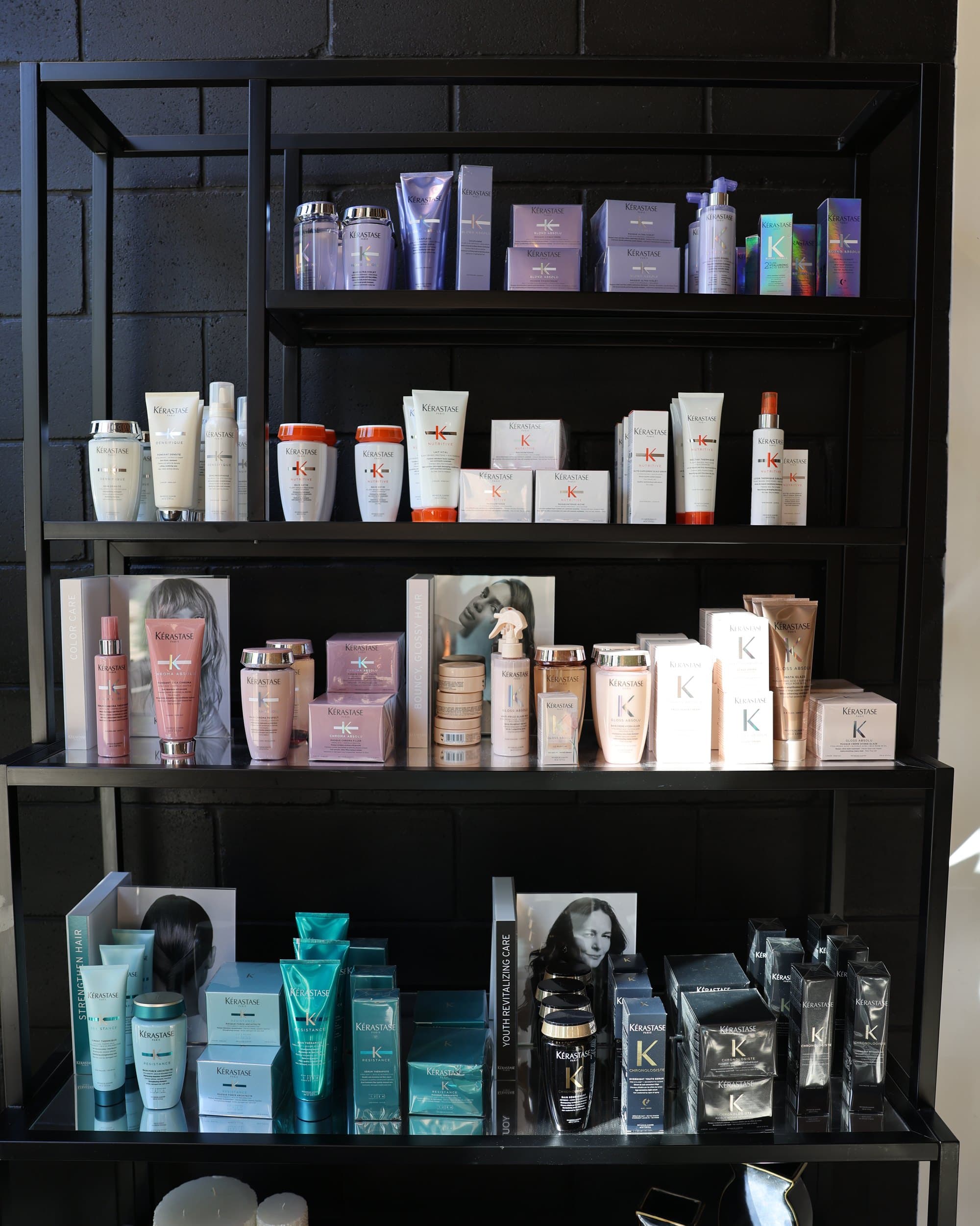 The black-wall Kérastase shelf: Blond Absolu, Nutritive, Chroma Absolu, Gloss Absolu, Résistance and Chronologiste