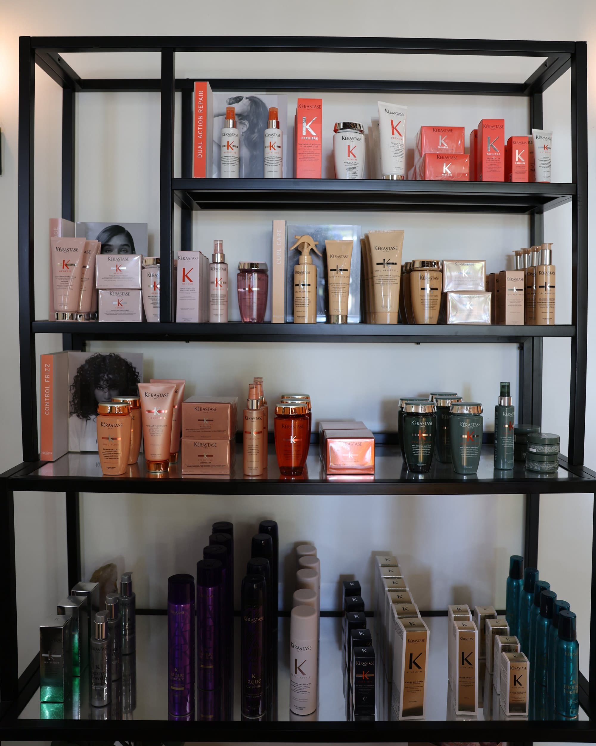 The white-wall Kérastase shelf: Première, Genesis, Curl Manifesto, Discipline, Spécifique and the Couture styling line